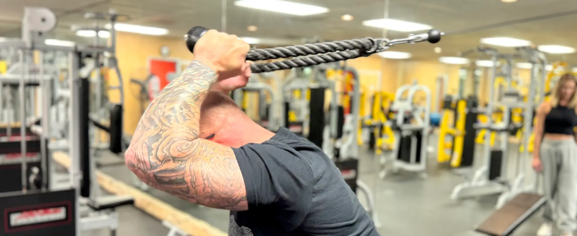 Member utilizes the cable pull machine at 777 Fitness and Wellness Center