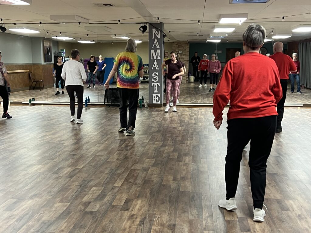 People participating in a Zumba group fitness class at 777 Fitness